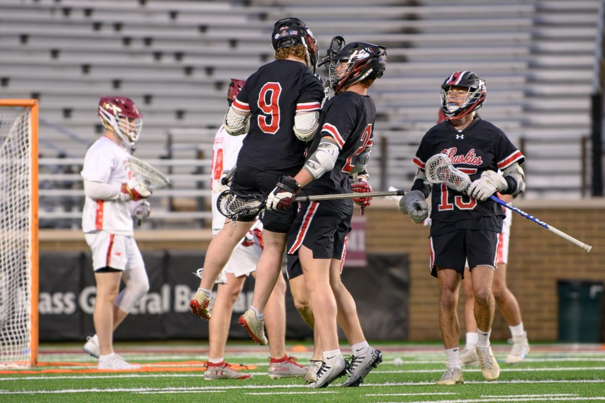 Brad Peterson celebrating with his teammates in a game the Huskies won last season against Boston College. Peterson hit 100 career goals last season. Photo courtesy Mika Podila. 