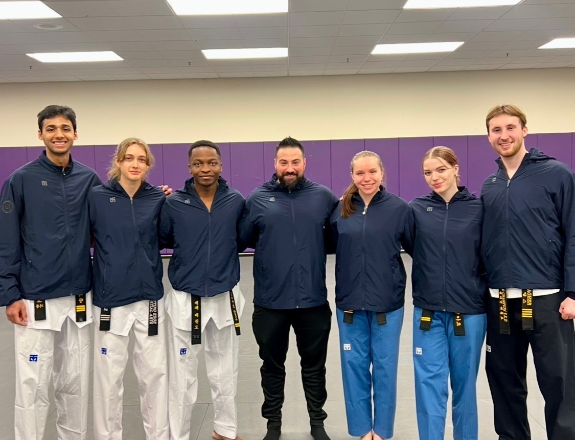 Ahbishek Narang, Taylor McMordie, Immanuel Mensah, coach George Panagiotakopoulos, Sarah Rescsanski, Sam Walker and Brian Meagher (left to right) stand for a photo. ECTC selected the six Northeastern team members for its All-star team. Photo courtesy Sam Walker.