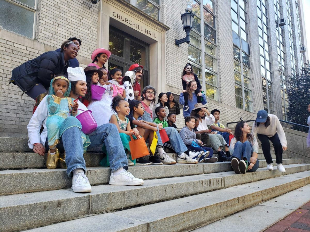 Members of DREAM and their mentees sit on the steps of Churchill Hall to take a photo while in costume. DREAM members participated in a range of activities, from rock climbing to visiting a fire station. Photo courtesy DREAM.