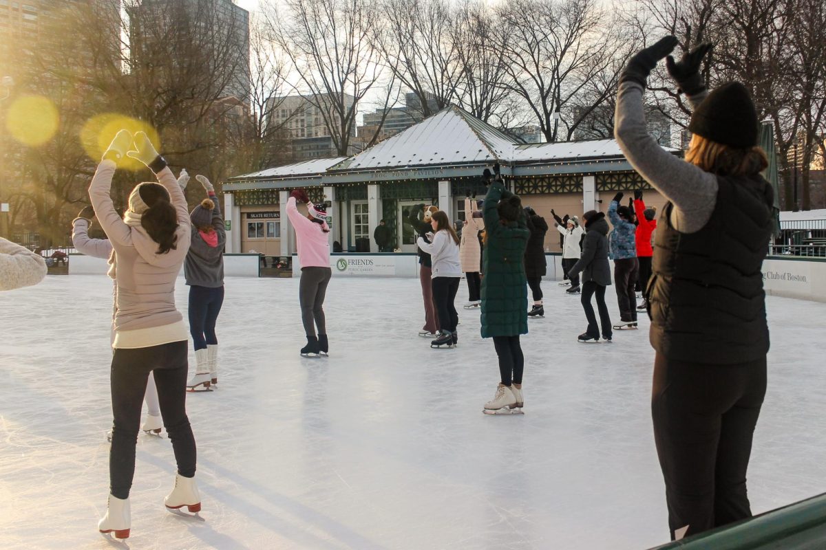 IceFlow class attendees practice easy, gentle stretches on the ice. The event description emphasized that it was not a traditional yoga class, nor was it meant to improve skating skills; instead, it was aimed at gathering together to be mindful on the ice.