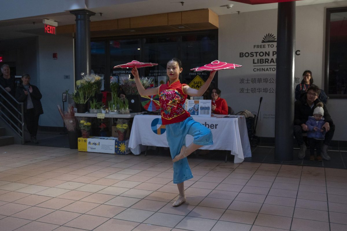 An 11-year-old dancer performs a traditional Chinese folk dance called Yangko. She spun decorated fabric squares on her fingers while performing acrobatic tricks including a cartwheel, split and handstand.