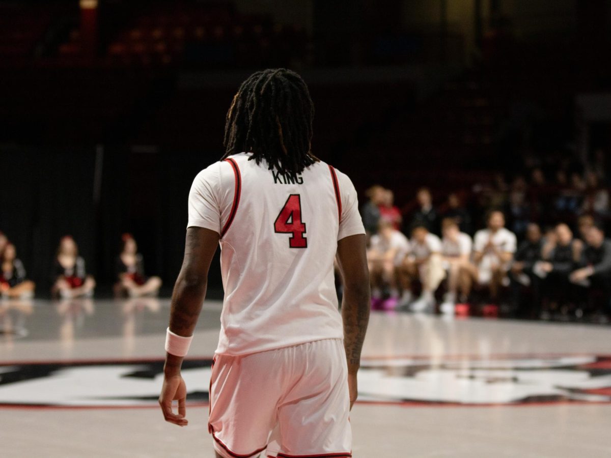 Rashad King looks down the court. King grew significantly in his average points per game going into the 2024-25 season. 