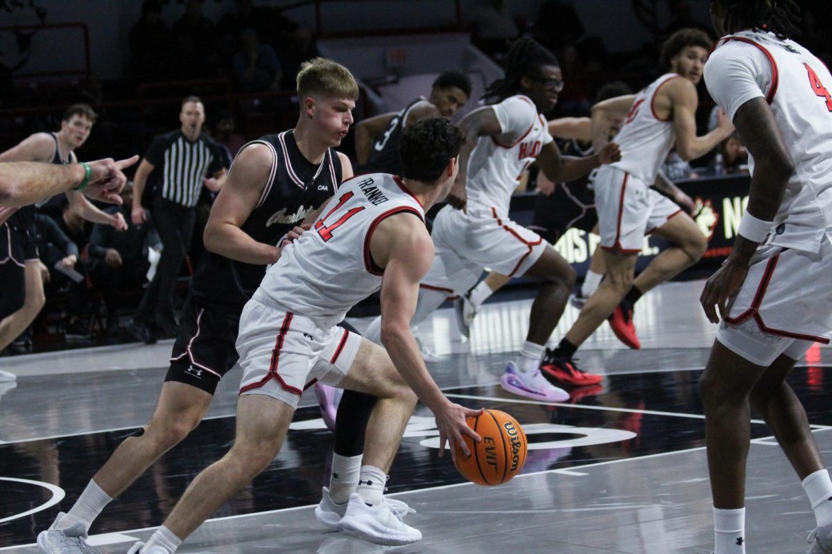 JB Frankel protects the ball against his defender Feb. 20. Frankel improved his free-throw percentage to .857 against Monmouth Feb. 24.