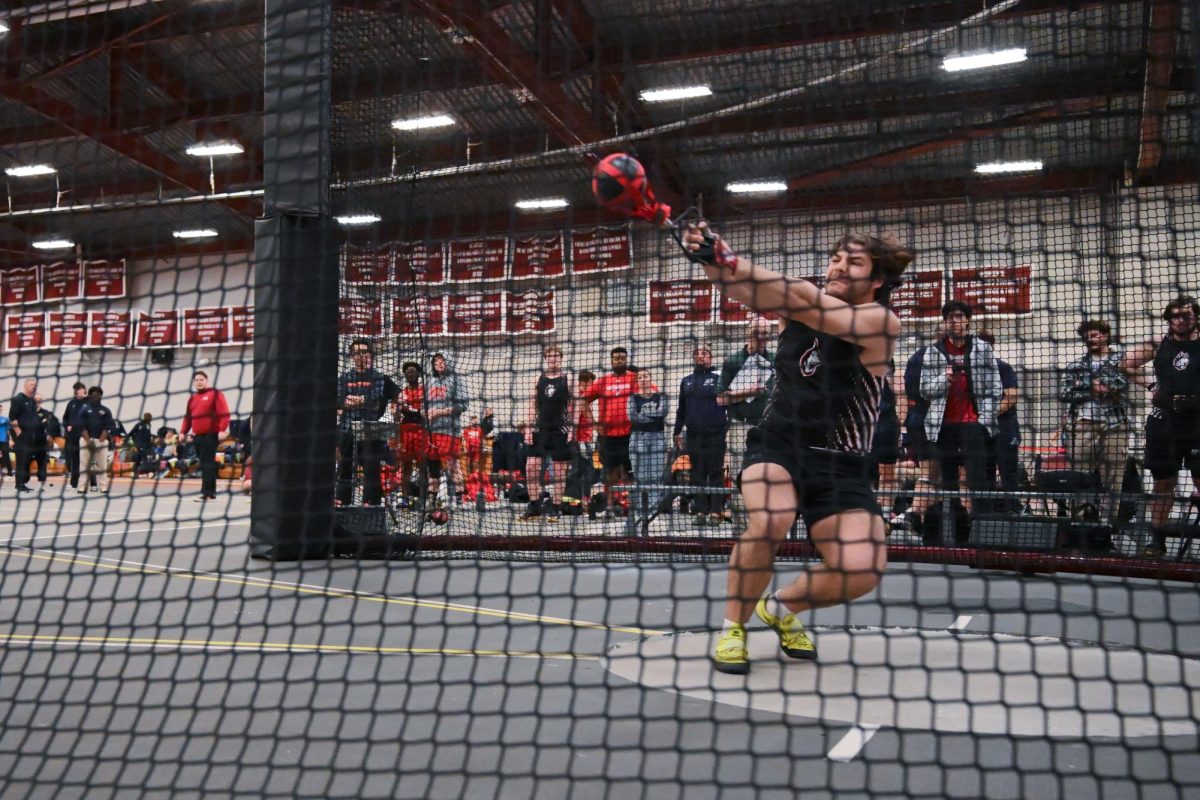 Nicholas Pisciotta participates in the weight throw Feb. 15. He recorded a new personal best in the men’s weight throw, winning the event at 19.20 meters.