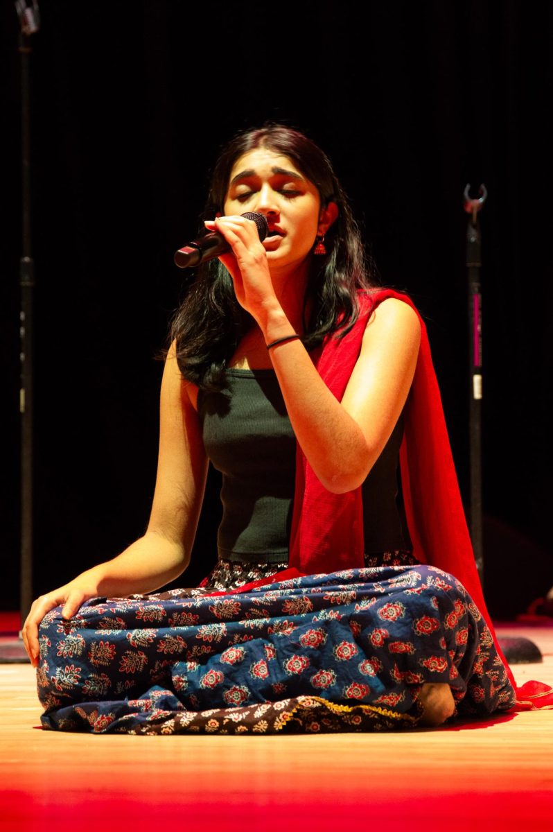 An Aaroh member sings in a classical set. Audience members sang along to the songs.