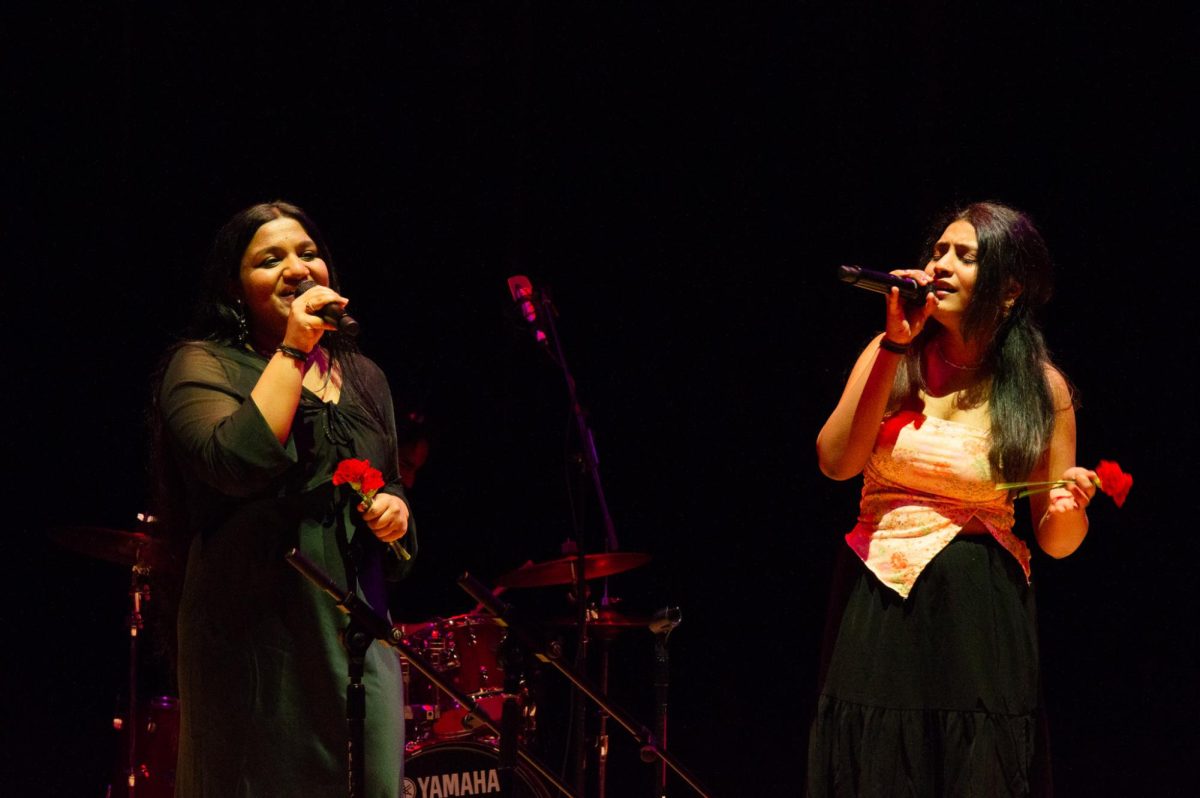 Two Aaroh members sing a South Indian set. They handed out flowers to the other singers in the set and the audience.