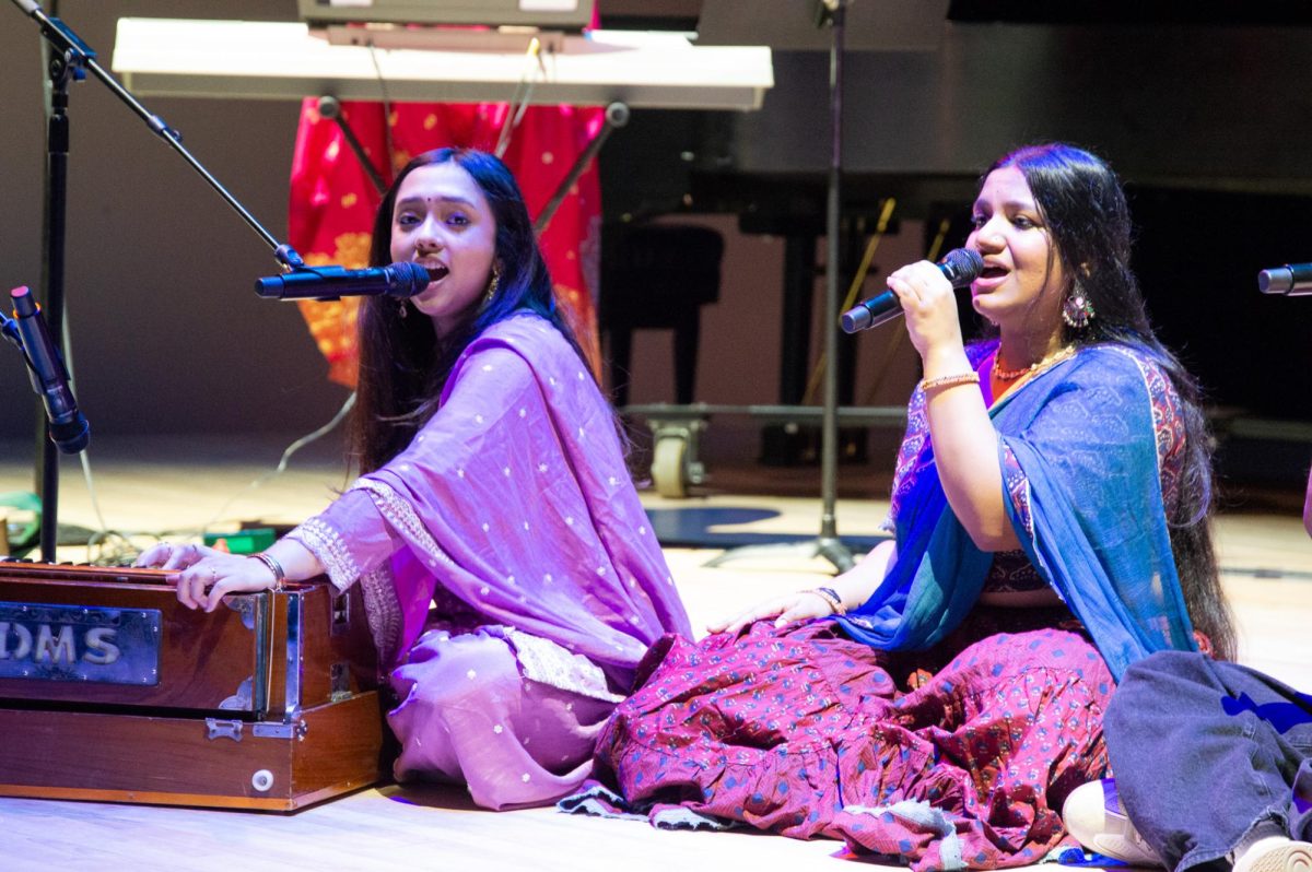 Two of Aaroh’s members sing in the middle of a classical portion. The left singer played the harmonium, whose soothing melodies were key during the songs.