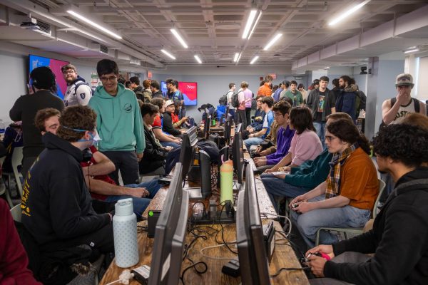 Gamers and guests alike gather around the center aisle to participate in Swiss rounds and cheer on their friends. The tournament lasted from 10 a.m. to 10 p.m.