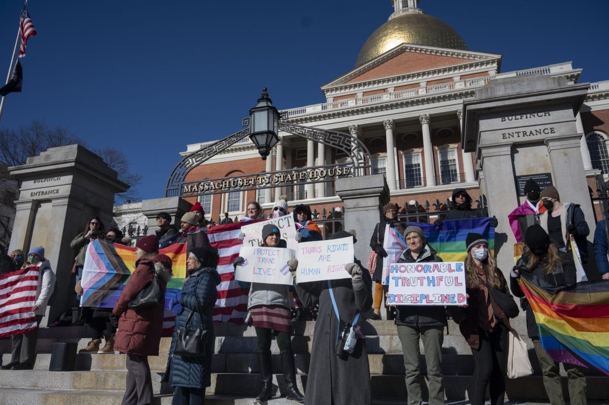 Protesters rally in front of the Massachusetts State House. They brought a variety of pride flags and handwritten signs.