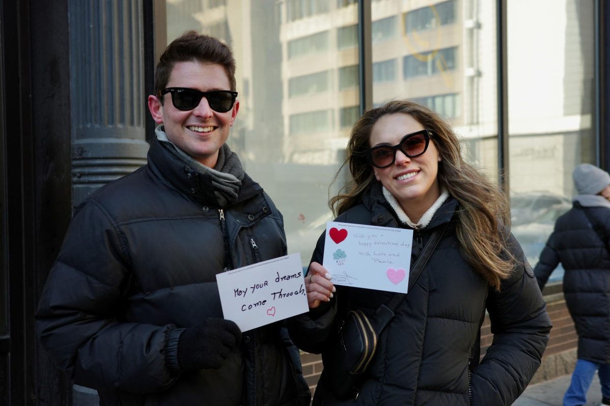 A couple poses with their new Valentine’s Day cards. They proceeded to thank those that made the cards possible.