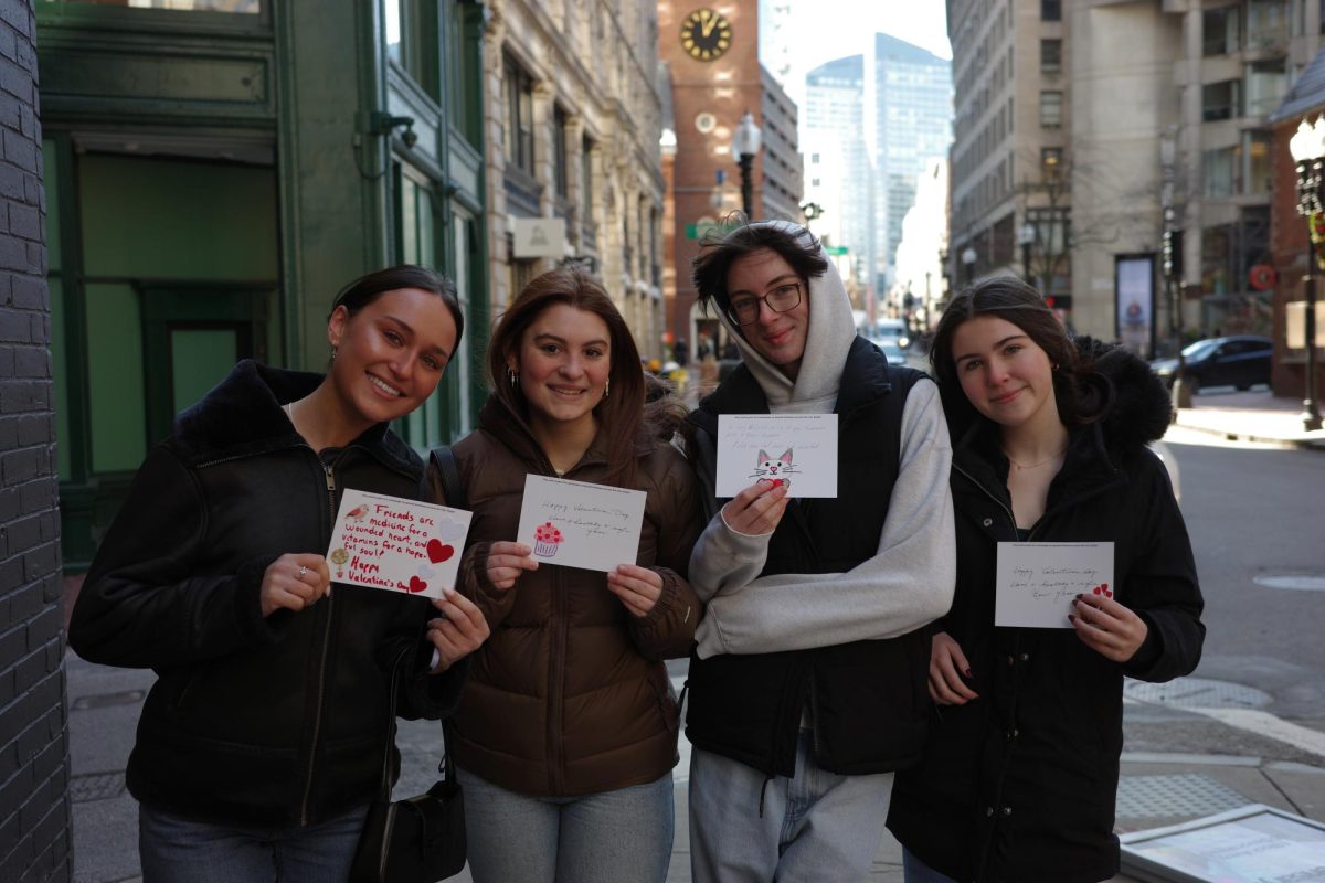 Out-of-town visitors receive Valentine’s Day cards in downtown Boston. The group exchanged smiles and cheerful remarks, feeling Bostonian’s efforts to spread positivity.