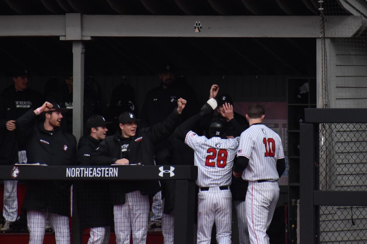 The Huskies celebrate their teammate March 29, 2024. Northeastern won one of their four games against Hawaii Feb. 29 to March 3.