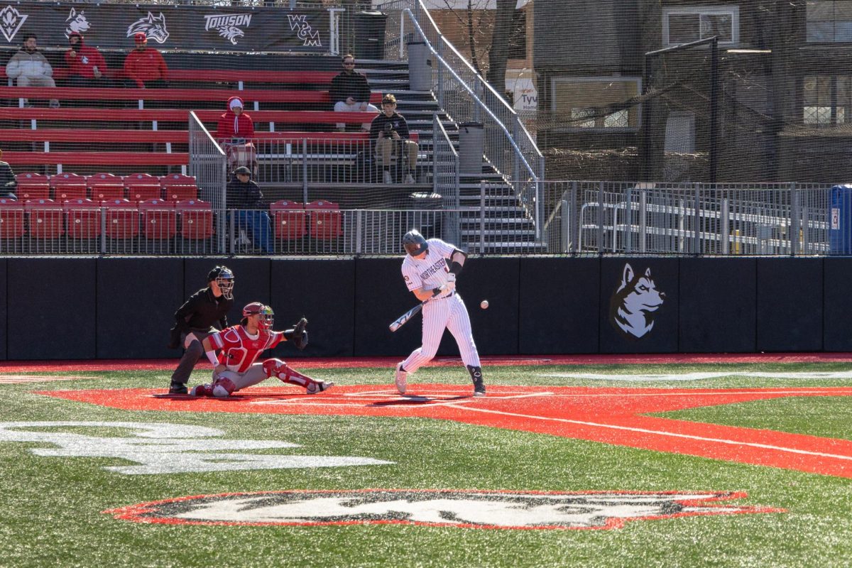 A Husky swings at the approaching ball. Northeastern lost to Bryant University 13-3 in seven innings.