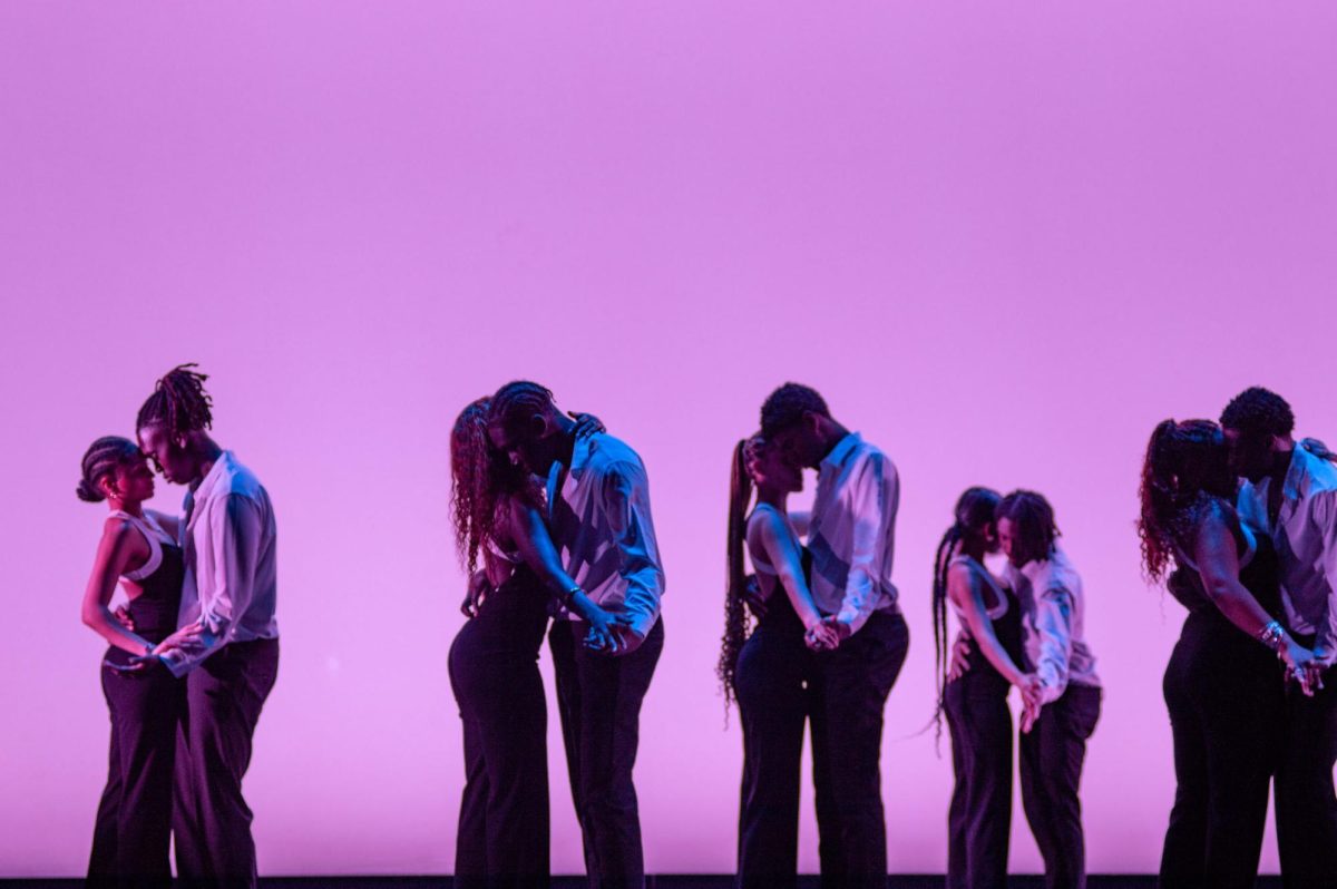 Performers stand in pairs and dance to kompa in front of a purple background. The routine featured intimate dances that captured the audience’s attention. 