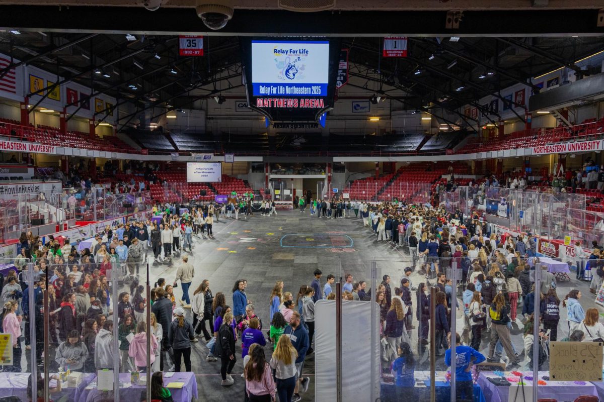 Students walk around the track in Matthews Arena. Nearly 2,000 students attended Relay for Life this year.