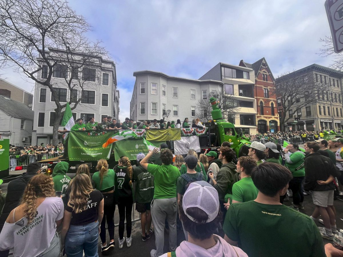 Spectators watch as a float passes by during the Boston St. Patrick's Day parade. The parade was especially popular with college students.