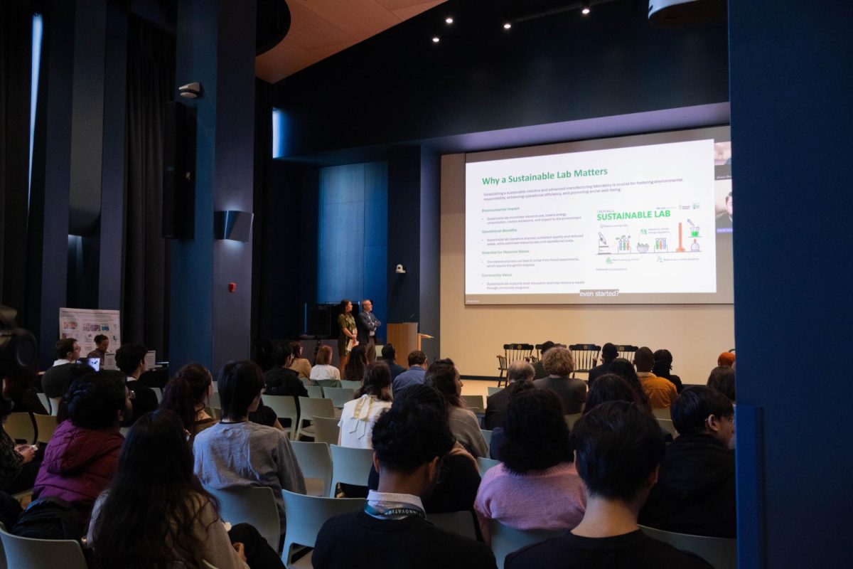 Students and faculty listen to a panel discussing environmentally forward-thinking architecture and laboratories. The conference covered topics such as climate change, recycling and more.