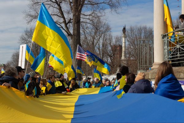 Demonstrators hold a large Ukrainian flag during a Feb. 23 demonstration planned by UCCN. While many volunteers and demonstrators were Ukrainian, UCCN also encouraged non-Ukrainians to participate in rallies and events.