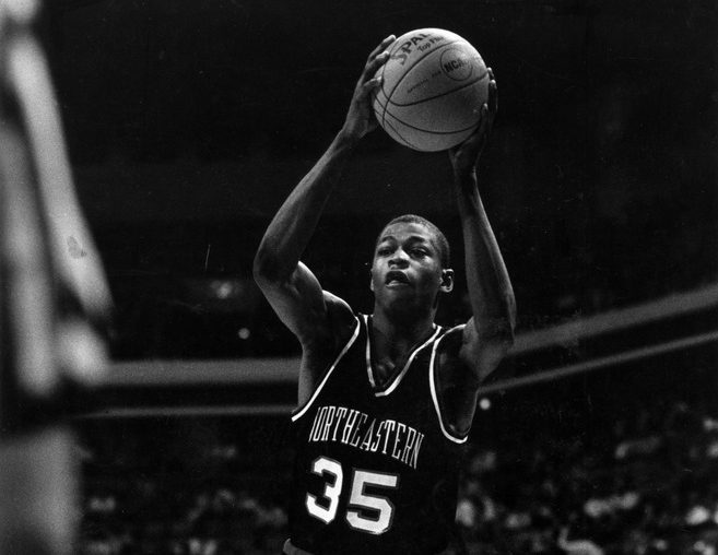 Reggie Lewis plays during a Northeastern basketball game. Photo courtesy of Joshua D. Levine and the Northeastern University photograph collection at Northeastern University Archives and Special Collections.