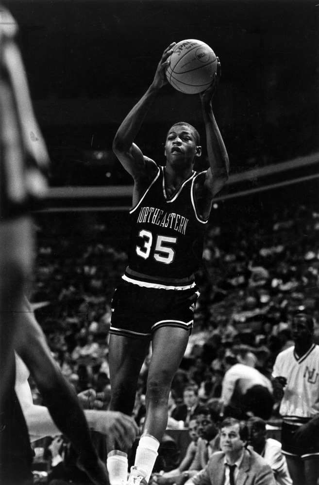 Reggie Lewis plays during a Northeastern basketball game. Photo courtesy of Joshua D. Levine and the Northeastern University photograph collection at Northeastern University Archives and Special Collections.