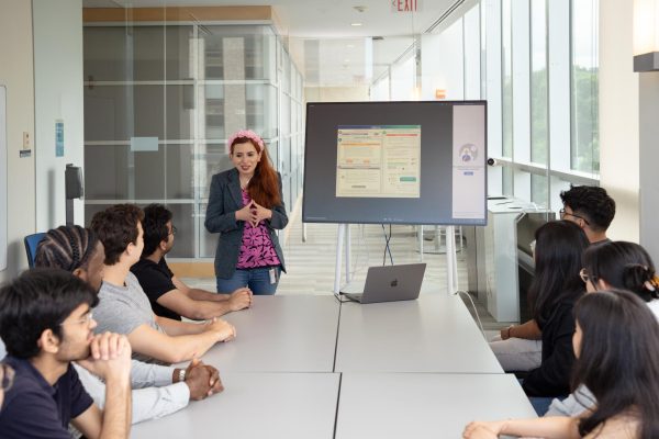 Dr. Saiph Savage presents a powerpoint to a group of students June 11, 2024. Savage emphasized how AI helps with job searches. Photo courtesy Khoury College Photography Team