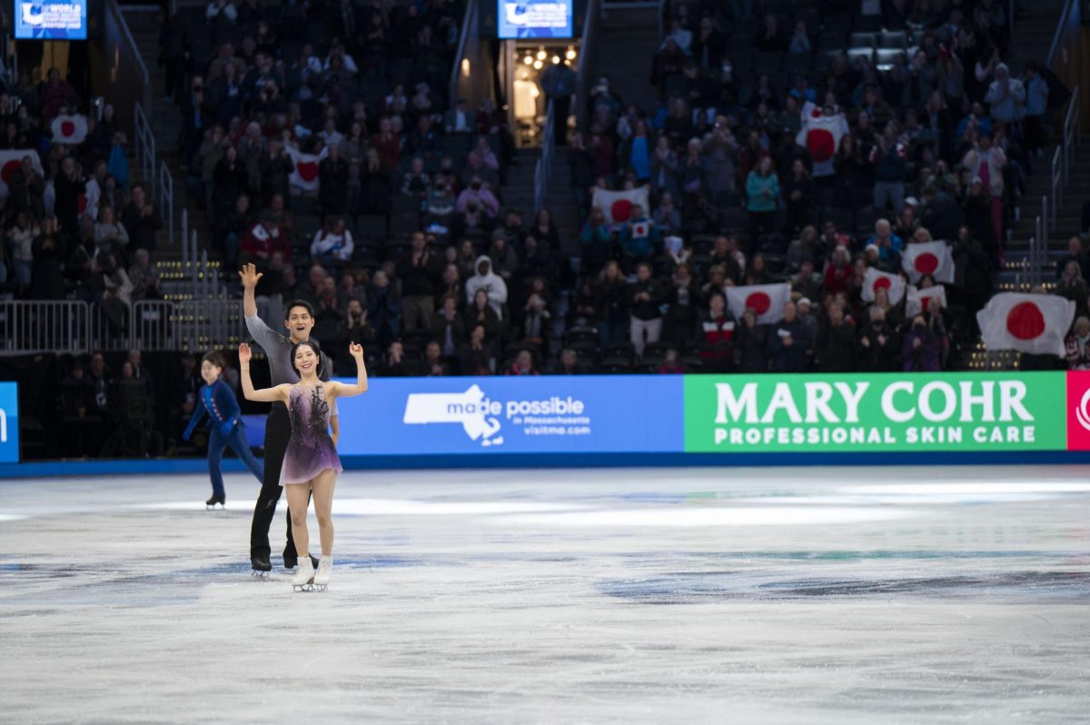 Kihara and Miura smile and raise their arms as a sea of Japanese flags are held up behind them March 26. Attendees brought their country’s flag, plushies and flowers to support their favorite skaters during the championship.
