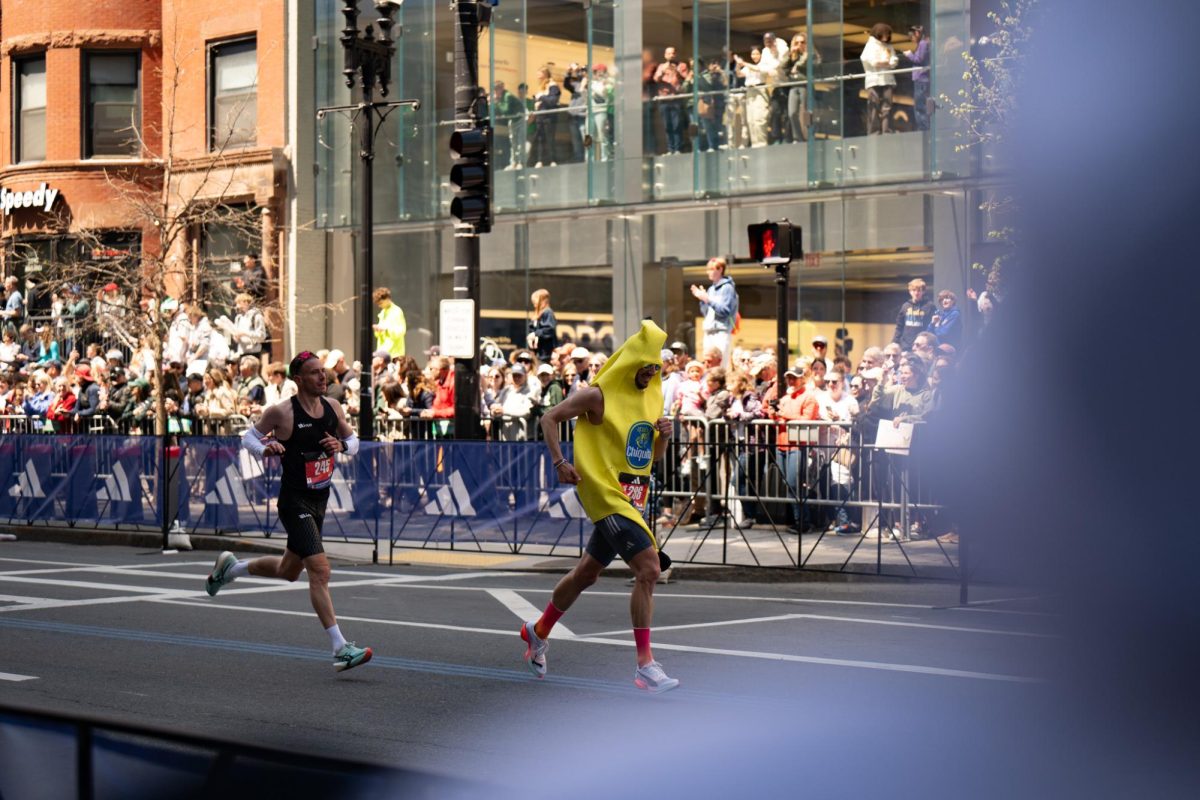 Dressed as a banana, Jordan Maddocks runs with Dorian Louvet (left) as spectators line Boylston Street and balconies above April 21. Read more here.