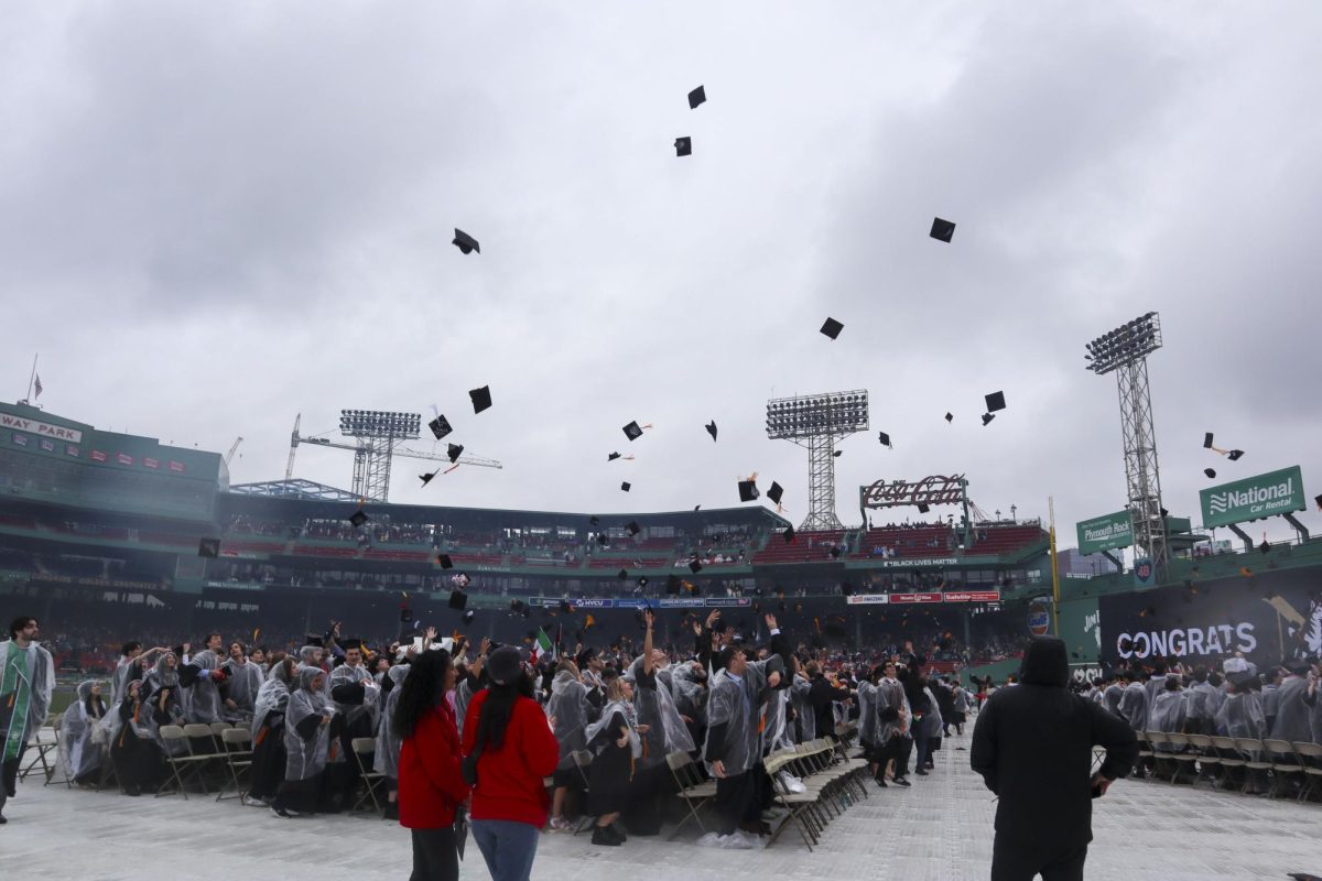 Northeastern graduates toss their caps into the air during the graduation ceremony at Fenway Park May 5, 2024. David A. Thomas, the president of Morehouse College in Atlanta, spoke at last year's undergraduate commencement.