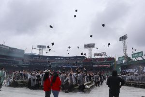 Northeastern graduates toss their caps into the air during the graduation ceremony at Fenway Park May 5, 2024. David A. Thomas, the president of Morehouse College in Atlanta, spoke at last year's undergraduate commencement.