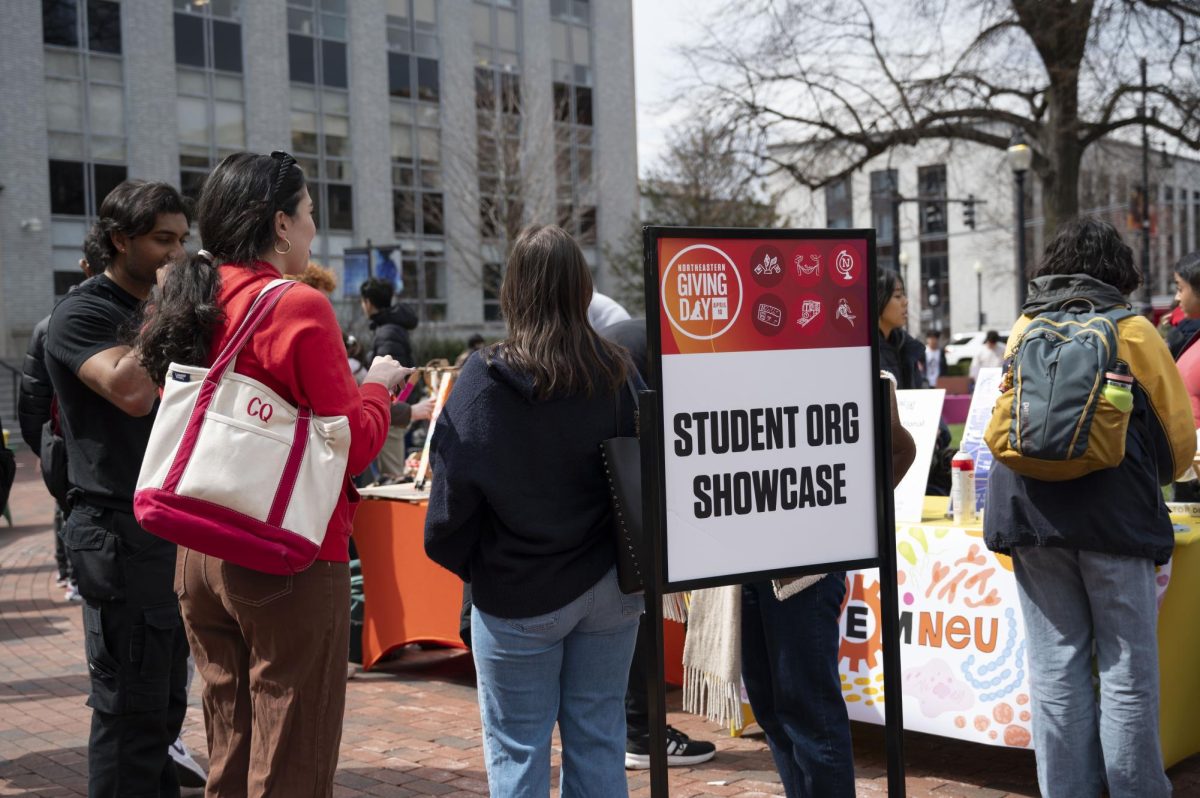 Students browse organization showcases in Krentzman Quad April 10. Student-led clubs, associations and varsity sports teams spent the day campaigning for donations through informational table displays and all day challenges.