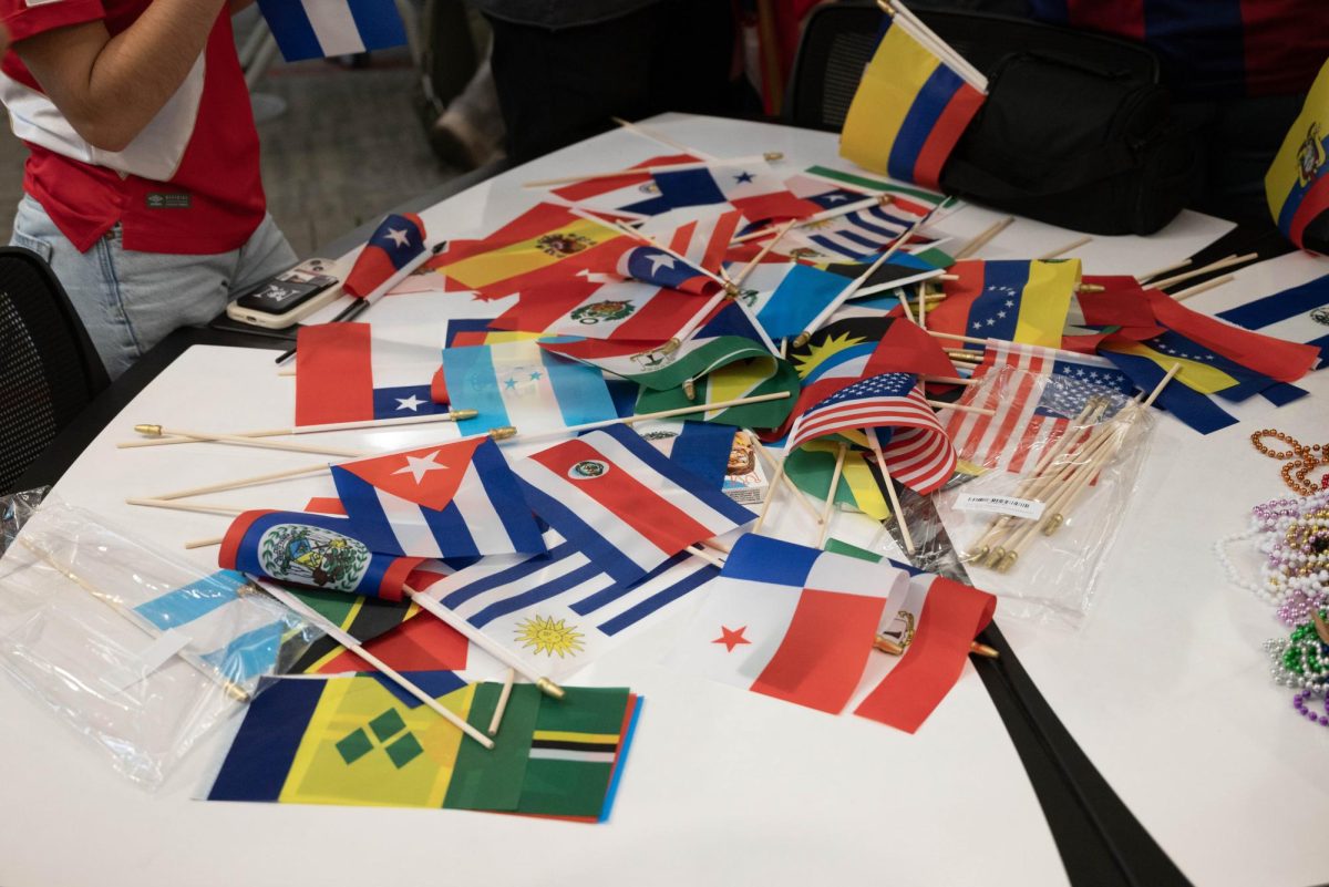 A collection of flags, from countries such as the United States and Cuba, sit on a table. The federal government has revoked over 1,000 international students' visas since the beginning of 2025, including more than 40 Northeastern students and recent graduates.