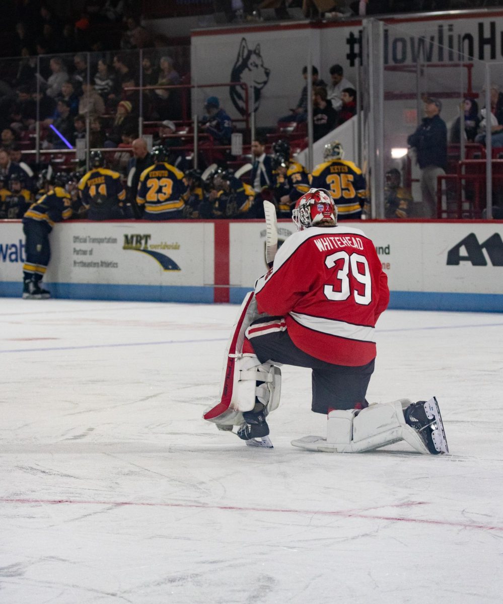 Cameron Whitehead kneels during a media break Jan. 25. During these breaks, the goaltender tried to recenter himself and appreciate his time on the ice. 