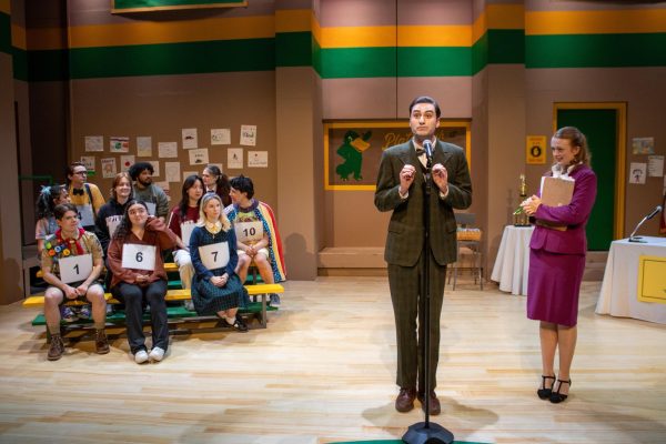 The "25th Annual Putnam County Spelling Bee" cast and invited audience members gather for the competition, sitting on bleachers and announcing the rules. The show included colorful costumes that matched each character's backstory. Photo courtesy Ashley DiLorenzo.