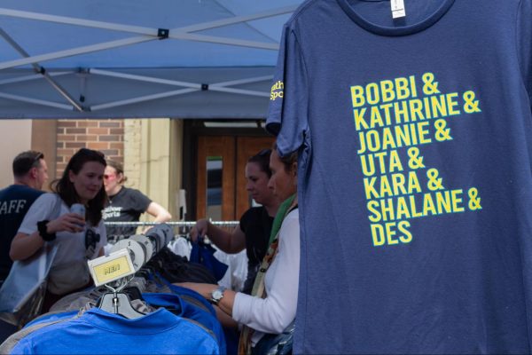 A t-shirt featuring the names of the famous women who participated in the Boston Marathon hangs at the Marathon Sports tent near the finish line April 19. The shirt was one of many products sold at pop-ups along the course highlighting the achievements of female runners.