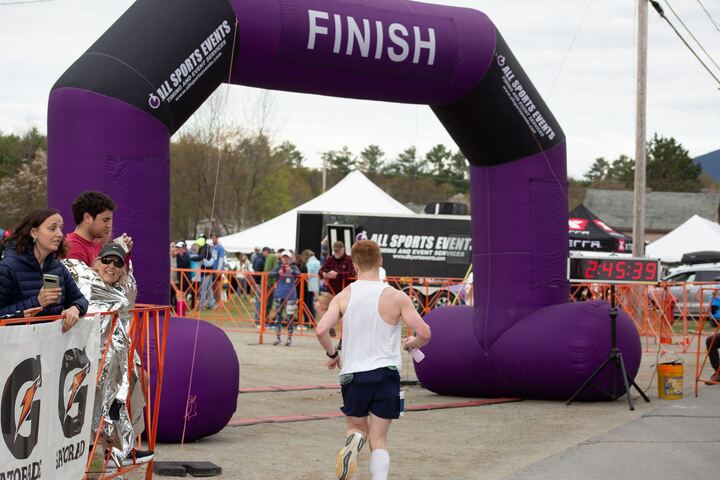 Jonathon Piesik crosses the finish line of a race. Piesik ran two marathons before the 2025 Boston Marathon. 