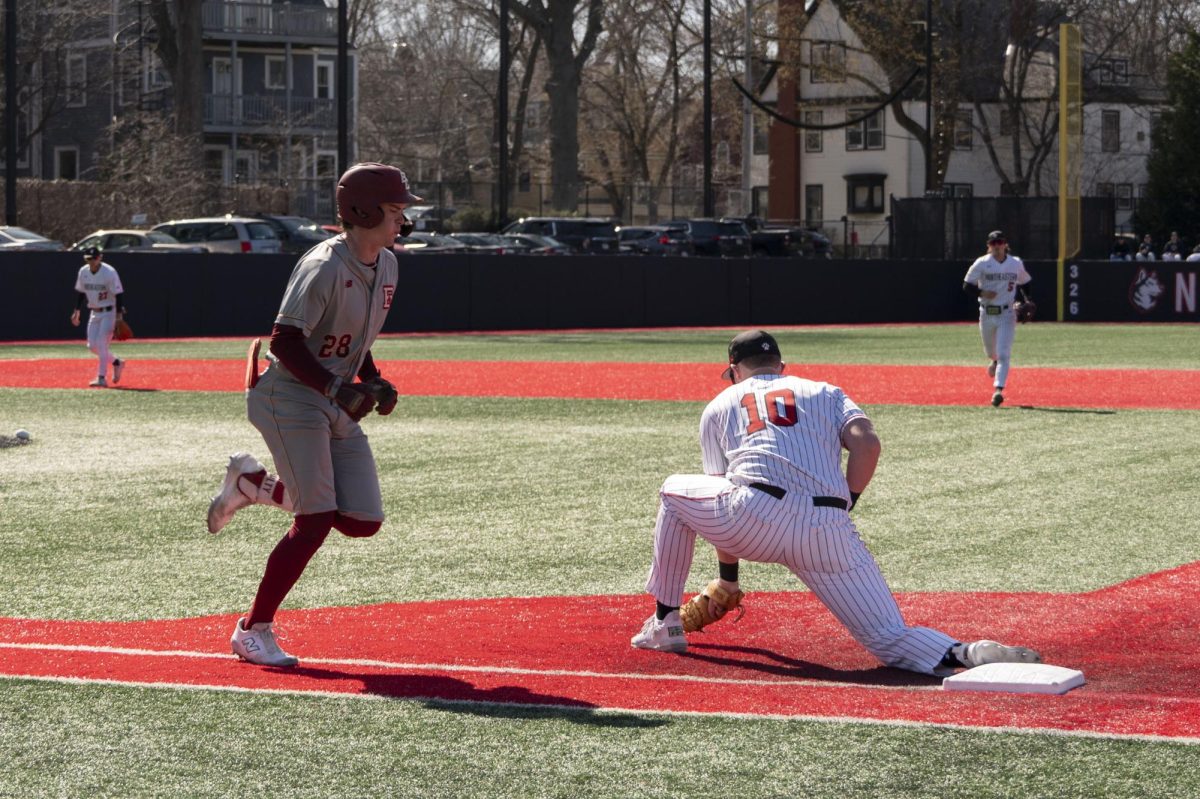 Alex Lane grabs the ball to take out a Boston College player April 1. The team won 21 consecutive games after defeating UConn May 13, the longest win streak in program history. File photo Jessica Xing.