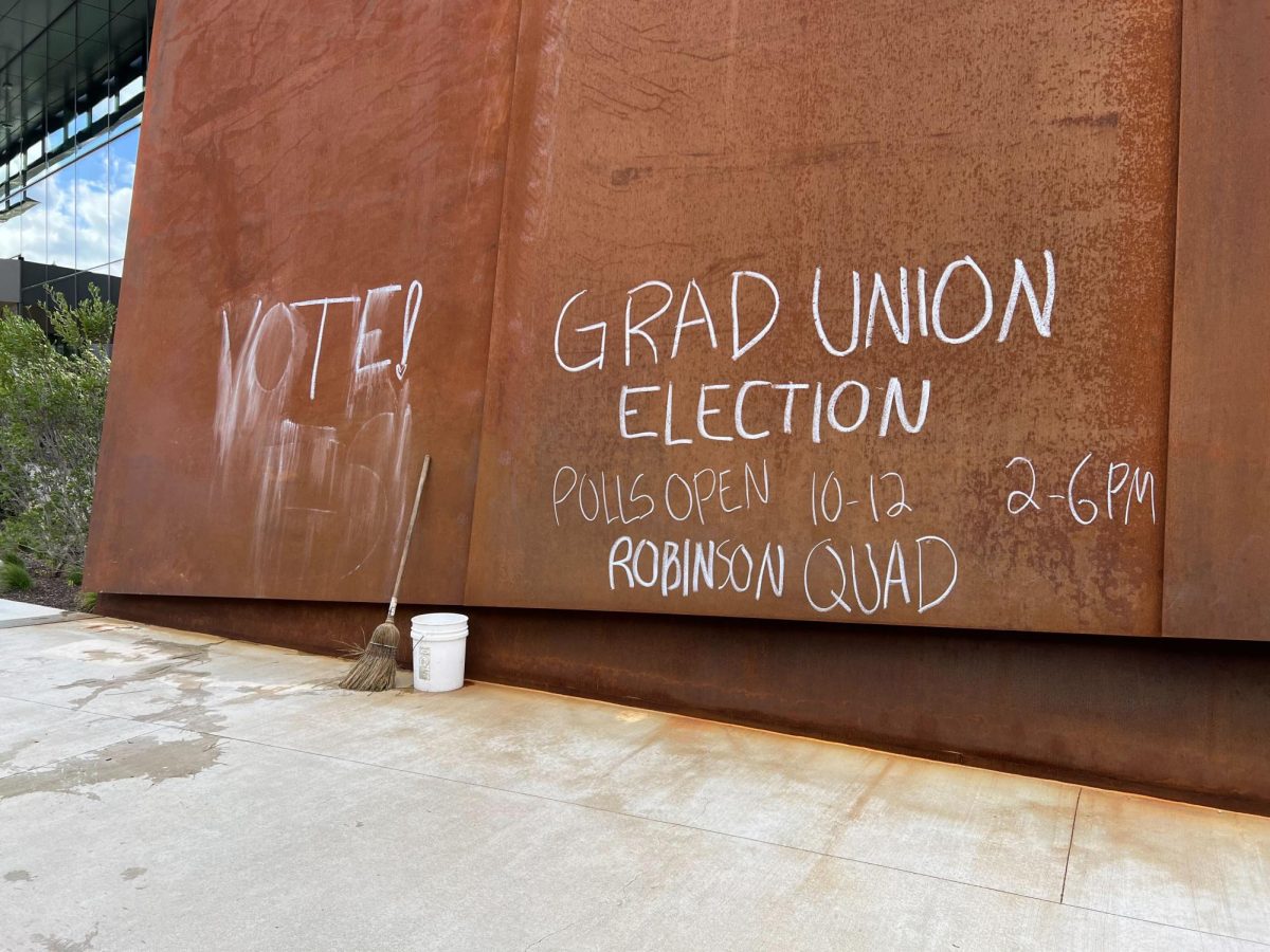 Chalk messages on the Interdisciplinary Science and Engineering Complex bridge encouraging graduate students to vote Sept. 19, 2023. GENU-UAW has been in negotiations with the university for 17 months. 