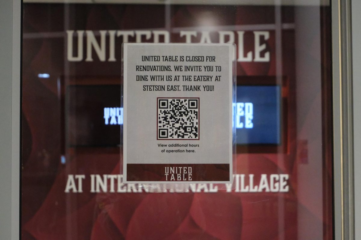 A sign reading, "United Table is closed for renovations. We invite you to dine with at the eatery at Stetson East. Thank You!" on the International Village dining hall entrance. The university announced sections of the Stetson East dining hall will be closed until June.