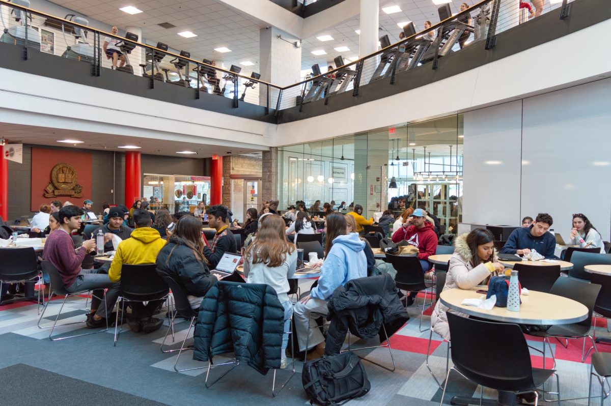 Students and community members occupy atrium tables at Marino Recreation Center. The fitness facility offered daily workout classes and scheduled recreational activities including open basketball, volleyball and badminton last semester.