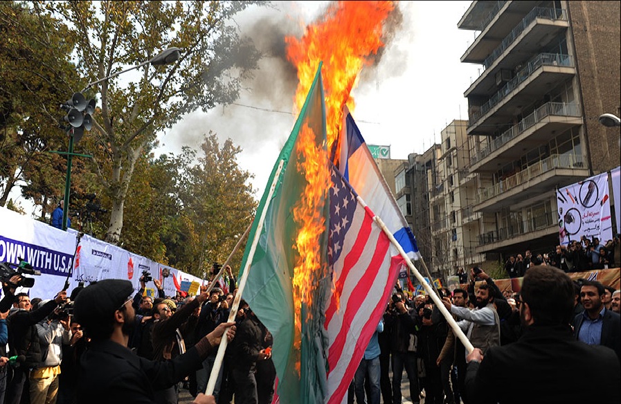 Protestors in Tehran, Iran burn the national flags of Israel, United States and Saudi Arabia Nov. 11, 2015. Younger Americans expressed more skepticism toward U.S. involvement abroad than any generation before them. Photo courtesy Mohamad Sadegh Heydary, Wikimedia Commons