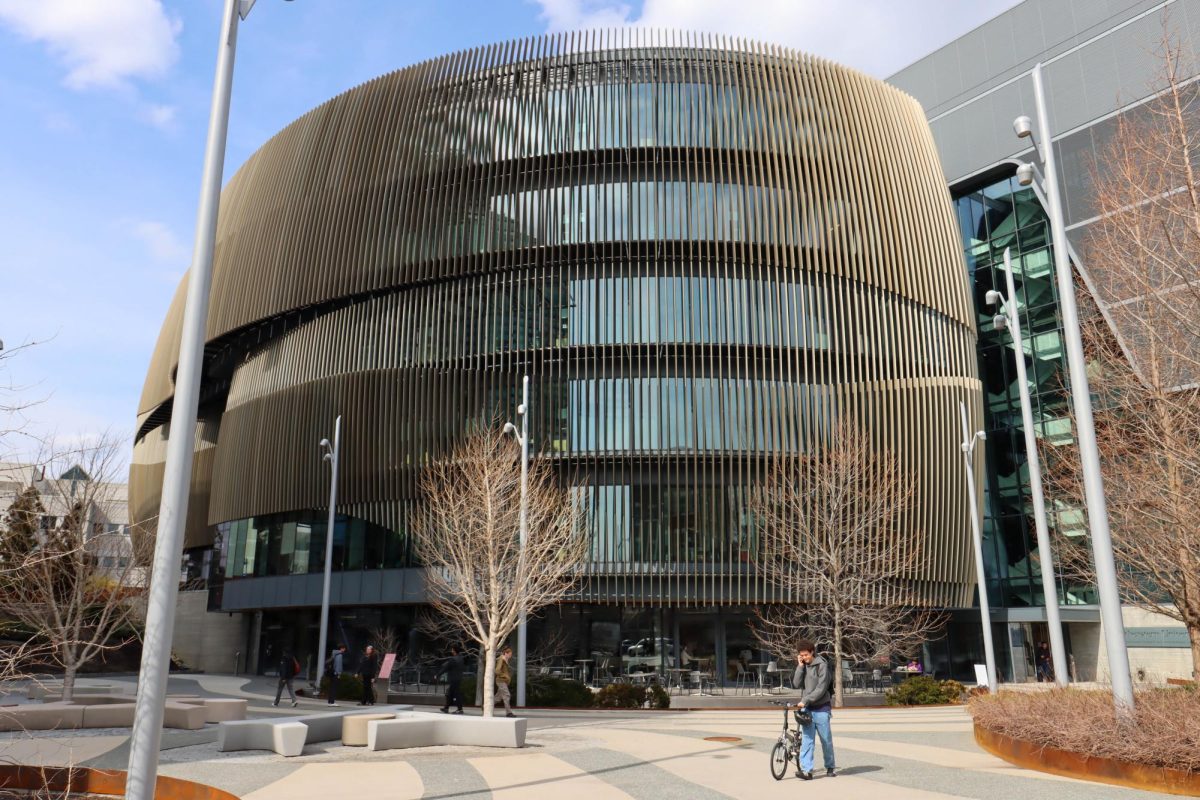 Students walk past the Interdisciplinary Science and Engineering Complex March 26. Nelson conducted research focusing on string phenomenology as part of the university’s theoretical high-energy physics group. 