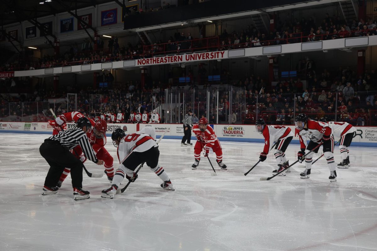 Tyler Fukakusa faces off against a BU player. The Huskies beat the Terriers 3-2 Nov. 21.