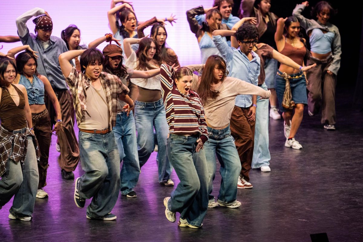 Unofficial Project members perform on the Blackman Auditorium stage Nov. 8. Seventeen dance groups gathered on campus to show off their routines and skills.