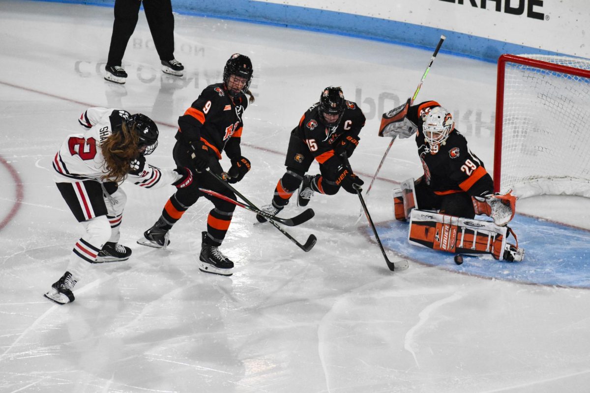Lily Shannon fights to put the puck in the net Oct. 3. Shannon scored four goals in the two games against Maine Nov. 21 and 21.