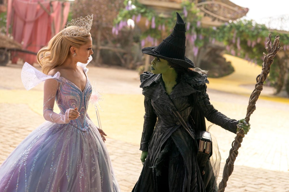 Glinda (Ariana Grande, left) and Elphaba (Cynthia Erivo) look at each other while in Munchkinland. The "Wicked: For Good" movie was released nearly a year after "Wicked." Photo courtesy Giles Keyte/Universal Pictures.