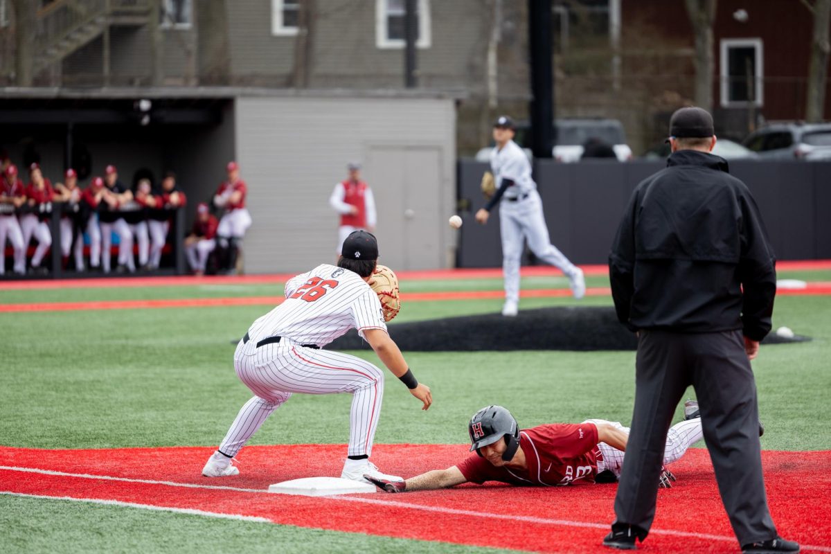Freshman first baseman Eric Cha catches a pass from the pitcher as a Harvard player dives at a game March 16. Read more here.
