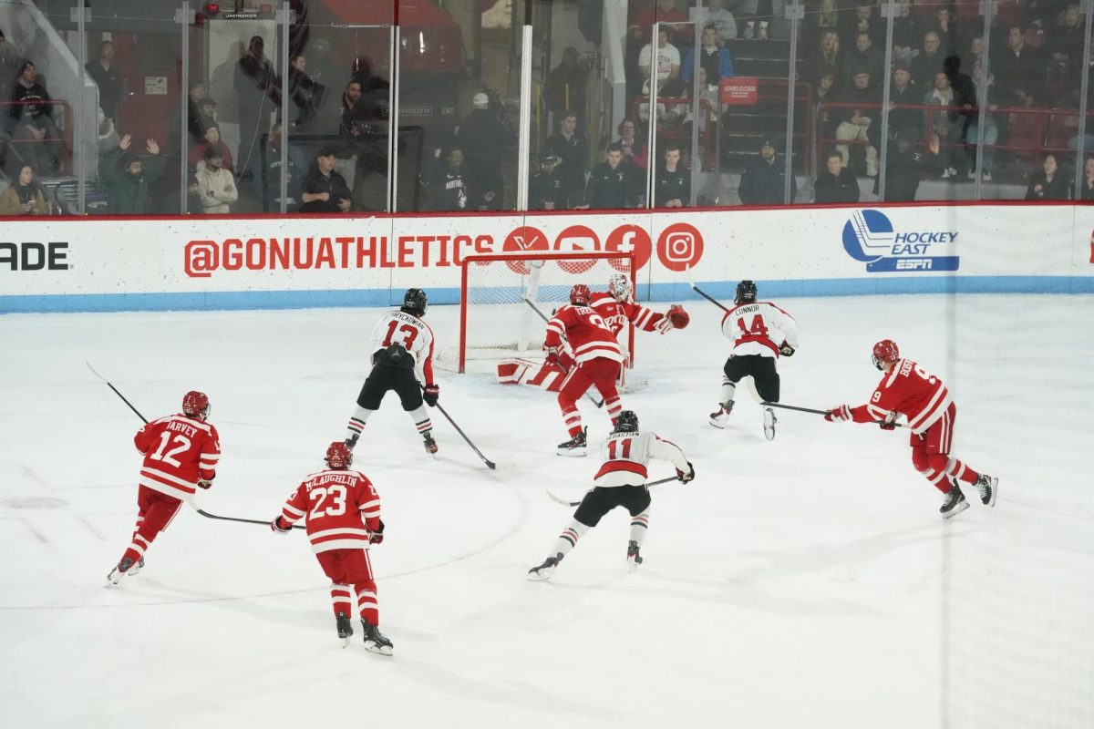 Sophomore forward Joe Connor (far right) flicks the puck into the net. Connor scored the third and final goal for Northeastern Dec. 13.