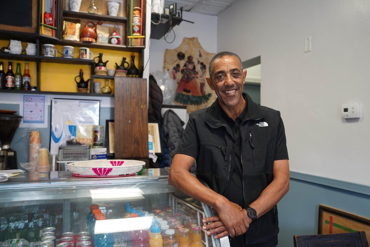 Befekadu Defar poses for a photo in Fasika Cafe Nov. 11. The cafe became well-known for their flavorful Ethiopian cuisine and coffee.