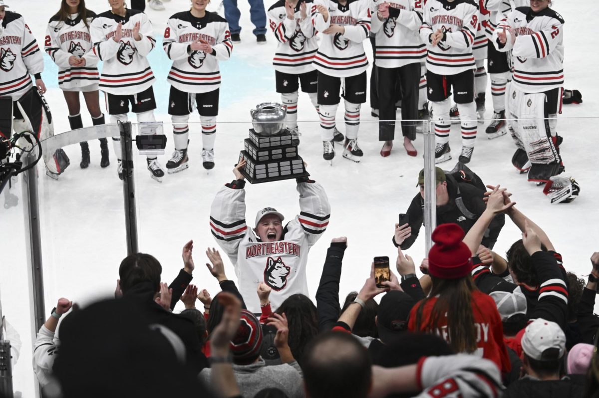 Sophomore goaltender Lisa Jönsson lifts the Beanpot Championship trophy in the air Jan. 21. The women's Beanpot championship and consolation games will be at TD Garden Jan. 20, 2026. File photo Jessica Xing.