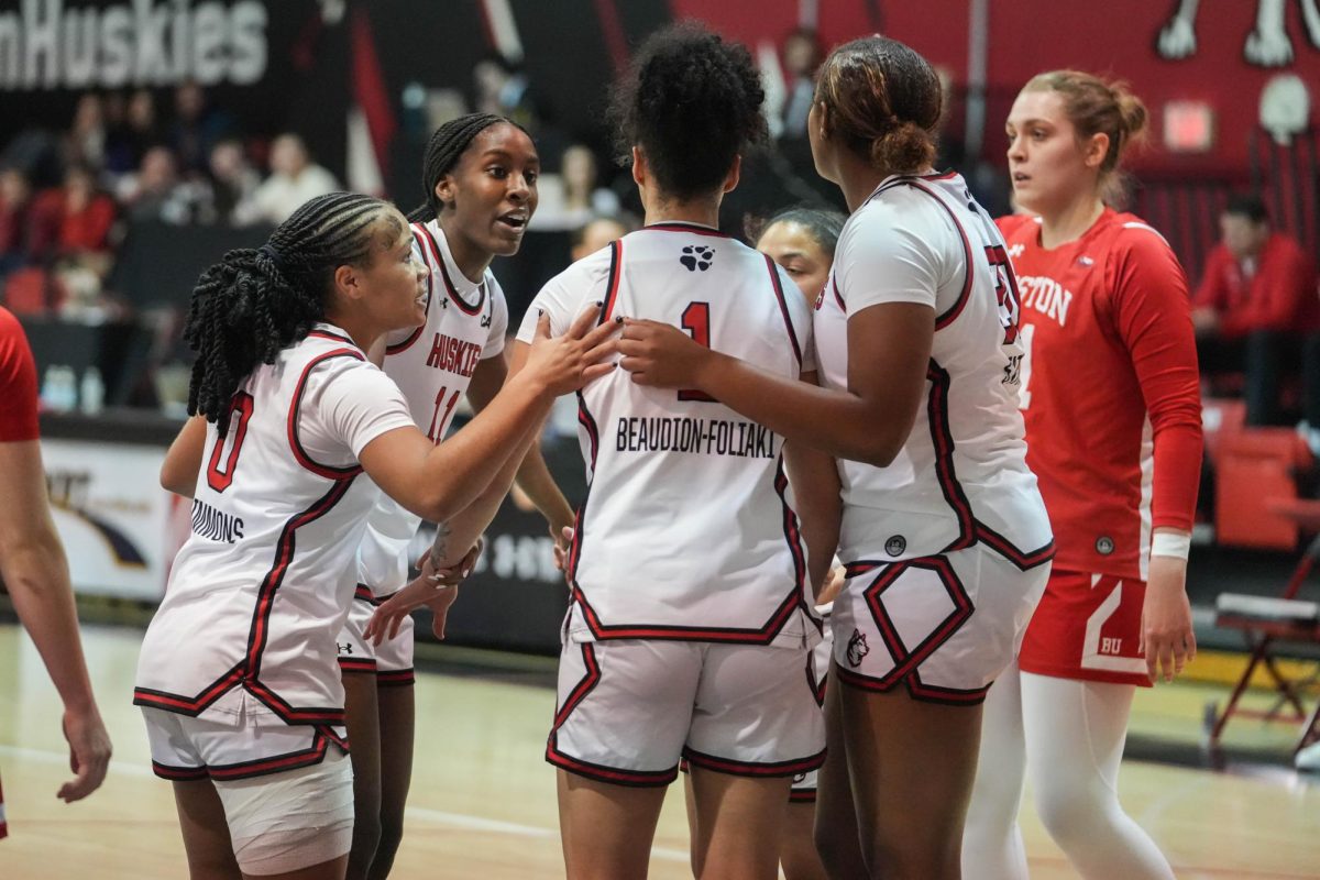 Northeastern teammates huddle to strategize Nov. 11. Northeastern won against Sacred Heart and UMass Lowell but fell to Rutgers for a 3-5 overall record.